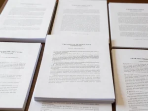 Overhead shot of legislative documents stacked on a committee hearing table, crisp typography, neutral daylight, high co